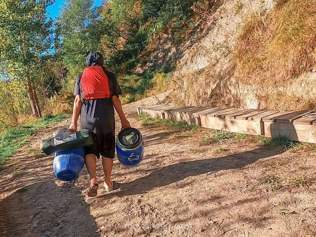 Carrying the baggage to Whakahoro Campsite, Whanganui River, Great Walk, New Zealand - RooWanders